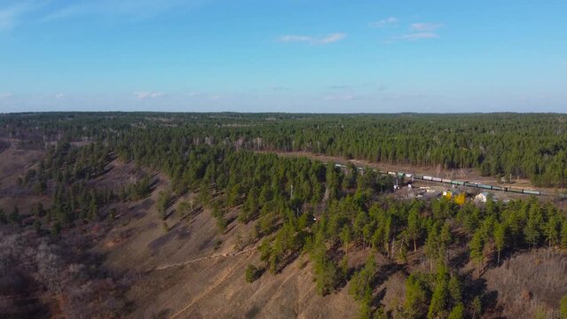 Autumn Overlook Aerial Views of Volga River, Forest, and the Grushinsky Festival Meadow in Warm Glow. Nature of Russia view from a drone in autumn