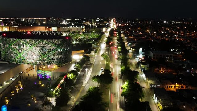 Aerial view of busy Merida cityscape at night with illuminated skyline and bustling traffic, Yucatan, Mexico.
