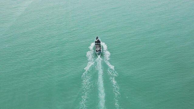 Aerial view of Celestun Beach with sailboat and speedboat, Yucatan, Mexico.