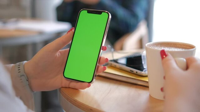Businesswoman, hands or green screen phone in coffee shop, restaurant or cafe on social media app or calendar management. worker employee or mobile technology mockup of office logo on lunch break 4K
