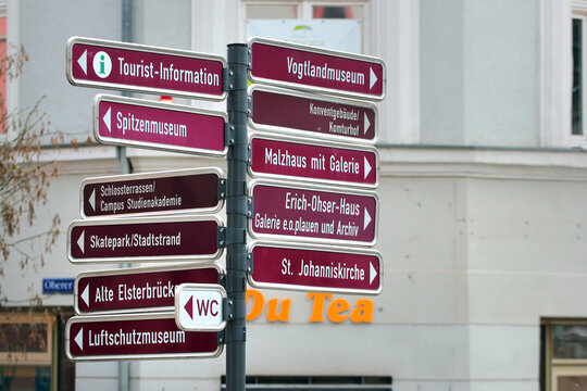 Plauen, Germany - March 28, 2023: Tourist information signpost on Town hall square with arrows pointing to main attractions of Plauen, Saxony