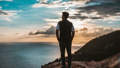 silhouette of a person on a cliff