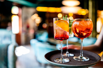 glasses alcohol cocktail set on a waiter tray in bar