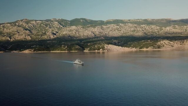 Aerial view of a beautiful bay with blue water and a boat, Rab Island, Croatia.
