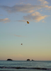 Parasailing on the beach, two parachutes in the distance over the water, Manuel Antonio, Costa Rica 