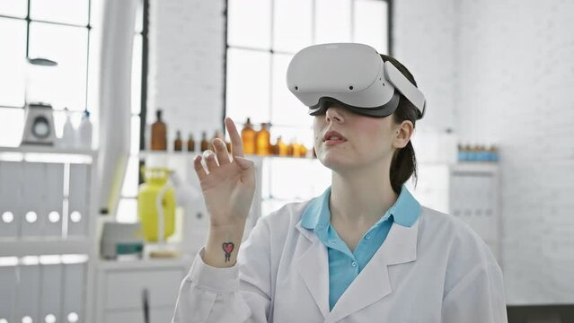 A young woman in a lab coat uses virtual reality headset in a bright medical laboratory.