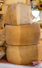 Heads of different types of cheese on the market.