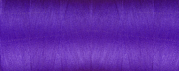 texture of thread for a sewing machine purple colors on a white background