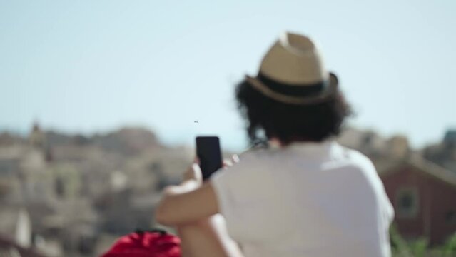 Traveler women taking photos with smartphone watching corfu town from new fortress in Corfu, Greece, slow motion