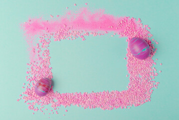 Easter holiday abstract composition with painted egg in fluid art technique and pink stones arranged in frame with copy space - 741465347