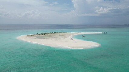 Aerial drone view of a sandbank with anchored dhoni, a traditional Maldivian boat, Vashafaru, Haa Alif Atoll, Maldives.