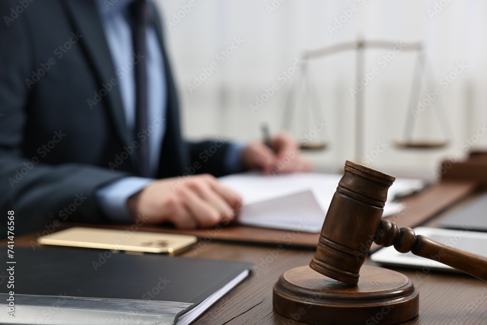 Poster Lawyer working with documents at wooden table, focus on gavel