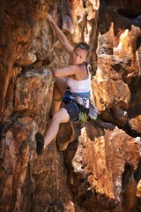Fotobehang Woman, mountain and rock climbing for exercise in outdoors, challenge and rope for training. Female person, cliff and extreme sport for fitness or workout, hiking and support to explore in nature © AW/peopleimages.com