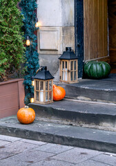 Beautiful decoration of orange and green pumpkins on the porch of a house. - 741477750