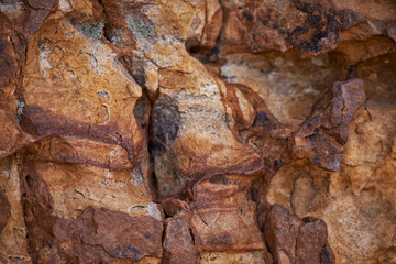 Rock face, closeup and mountain in nature, natural or travel outdoor with wall. Cliff, stone and environment for bouldering, climbing and texture of surface in summer on a background in South Africa