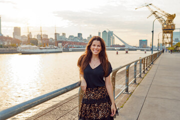 portrait beautiful latin American woman posing and smiling  outdoors in Puerto Madero	