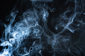 In the shroud of darkness, wisps of smoke rise and twist, casting ephemeral shadows upon the night.