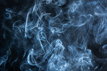 In the darkness, swirling wisps of smoke dance, painting mesmerizing images in the air.