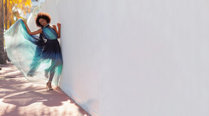 A beautiful black model in a flowing dress on the streets of Miami.