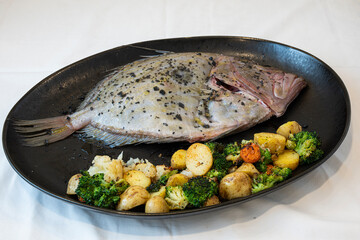 Fresh raw John Dory fish readty to be cooked with vegetables 