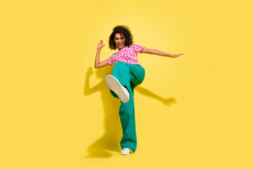 Fototapeta na wymiar Full body portrait of crazy cheerful lady dance leg kick shoe sole empty space isolated on yellow color background