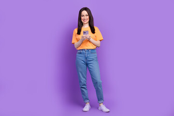 Full body size photo of satisfied seller woman using smartphone to send financial agreement email isolated on purple color background