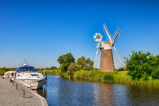 Norfolk Broads - Motor cruisers moored near Turf Fen Windmill on the Norfolk Broads, Norfolk, England