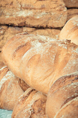 Fresh traditional loaves of wheat or rye bread on stall or in bakery