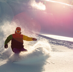 Snowboarding Powder Snow. A snowboarder making a powder turn on a piste covered with fresh snow on...