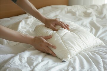 Obraz na płótnie Canvas individual setting an orthopedic pillow on clean white bedding