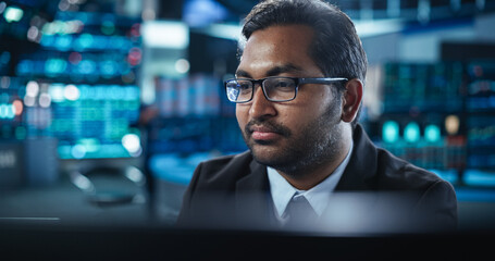 Portrait of a Young Indian Man Working in an International Stock Exchange Company: Happy Trader...
