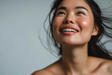 Beautiful confident young adult Asian woman posing for beauty portrait. Pretty smiling happy healthy girl student model from Asia looking at camera smiling on background. Close up face . - obrazy, fototapety, plakaty