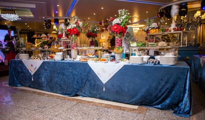 Lavishly decorated banquet table set with delicious food