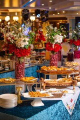 Delicious buffet spread with pastries, bread, and floral centerpieces.