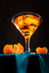 Citrus drink with tangerines and ice on a dark background. Bottom view.