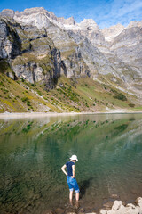 A petite lake nestled in the Swiss Alps, encircled by the towering Glärnisch mountains