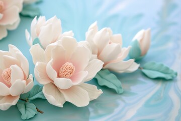 fondant magnolia flowers on blue icing