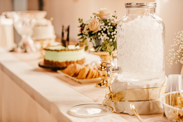 Wedding Cake and Wedding cookies displayed on a decorated table.