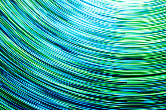 Neon circle lines with empty copy space inside isolated on black background. Colorful led lights long exposure rotation photo. Shiny light source. Cosmos space planet abstraction. Blue vortex spiral.	