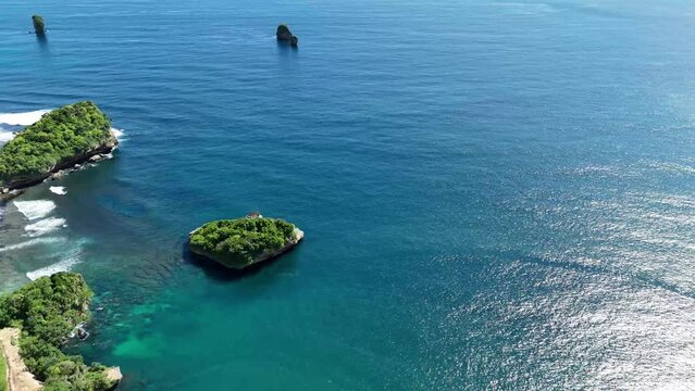 aerial view of tanjung penyu 
beach in malang east java indonesia, stunning sea view, cluster of small islands on the beach peninsula, wide coastline with white sand. beach with hills.