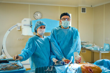 Surgeons perform complex surgery in the operating room