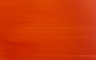 Red-orange wood floor The surface is smooth and has a faint wood grain. red wood background...