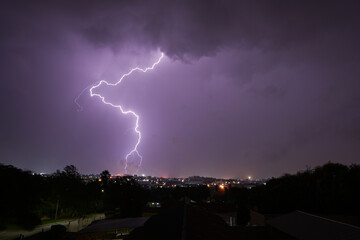 Stunning lightning strikes just before an incredible thunderstorm over a suburban home area. Showing the absolute strength that exists within nature - obrazy, fototapety, plakaty