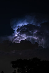 Beautiful cloud formation over a suburban home area with lightning striking within its self showing...