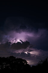 Beautiful cloud formation over a suburban home area with lightning striking within its self showing...