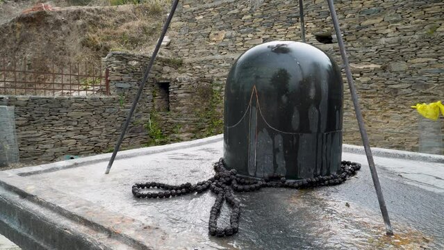 Granite stone Shivalinga's at Lakhamandal Shiva Temple. It shines like a mirror and reflects the surrounding view.