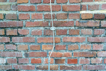 Lightning rod on a brick house wall - obrazy, fototapety, plakaty
