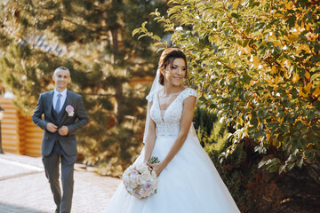 The moment of the first meeting of the bride and groom with a wedding bouquet, the bride is waiting...