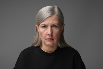 Personality concept. Portrait of emotional woman on gray background