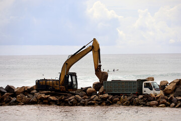 filling land in the sea, or land reclamation. construction of embankments to prevent abrasion and...